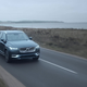 A photo of a Volvo XC90 SUV on a road.